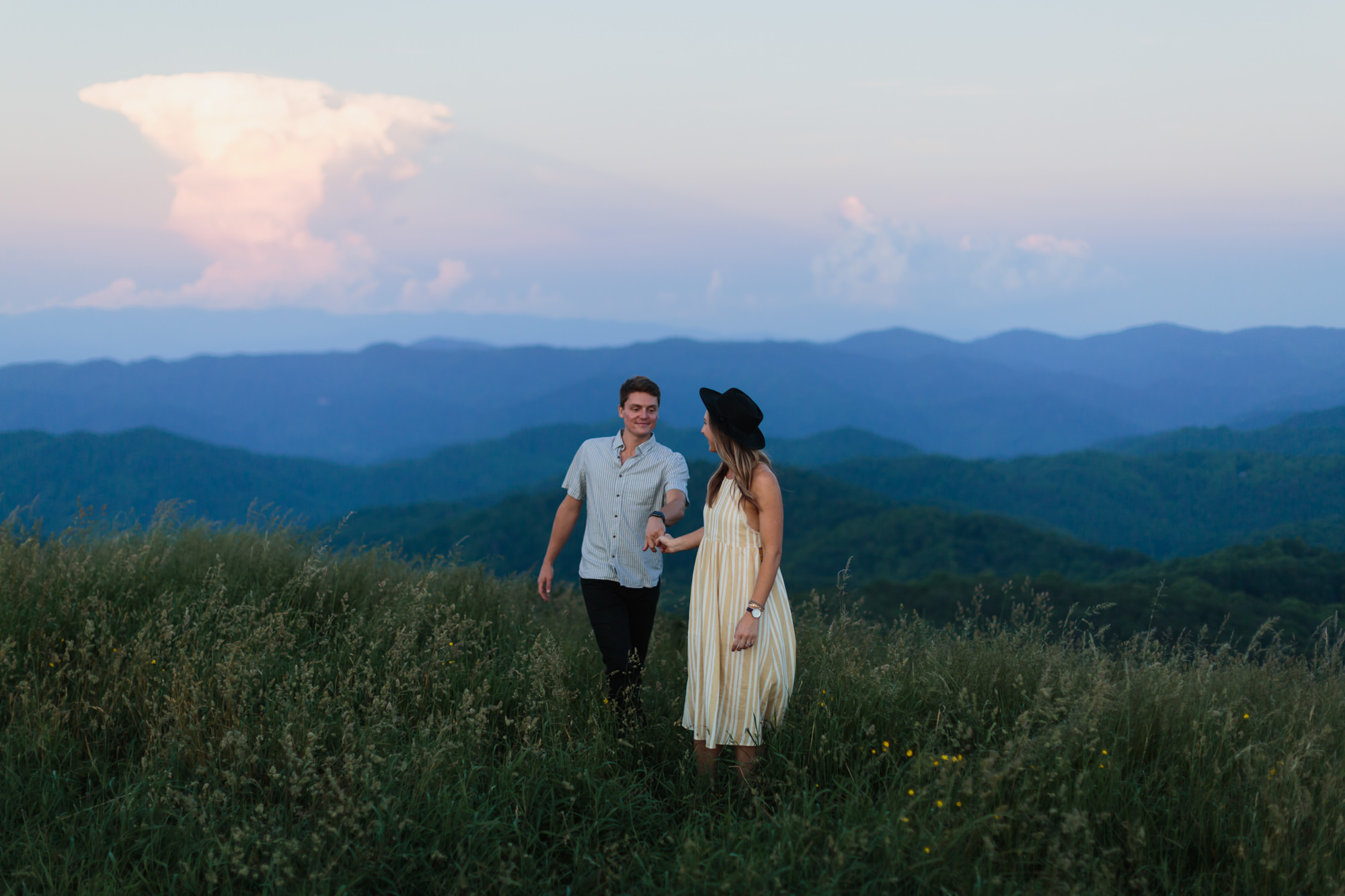 girl in dress leading guy on max patch, Nashville engagement, couples mountain, mountain engagement, couples camping, dog photography, Knoxville, couples hiking, camping with dog, North Carolina hiking, summer engagement photos, Tennessee Photography, Tennessee Photographer, Tennessee Photos, Tennessee Engagement Photography, Tennessee Engagement Photos, Tennessee Engagement Photographer, Tennessee Portrait Photographer, Nashville Engagement Photographer, Nashville Engagement Photos, Knoxville Engagement, Nashville Lifestyle Photographer, Nashville Lifestyle Photography, Nashville Lifestyle Photos, Creative Portraits