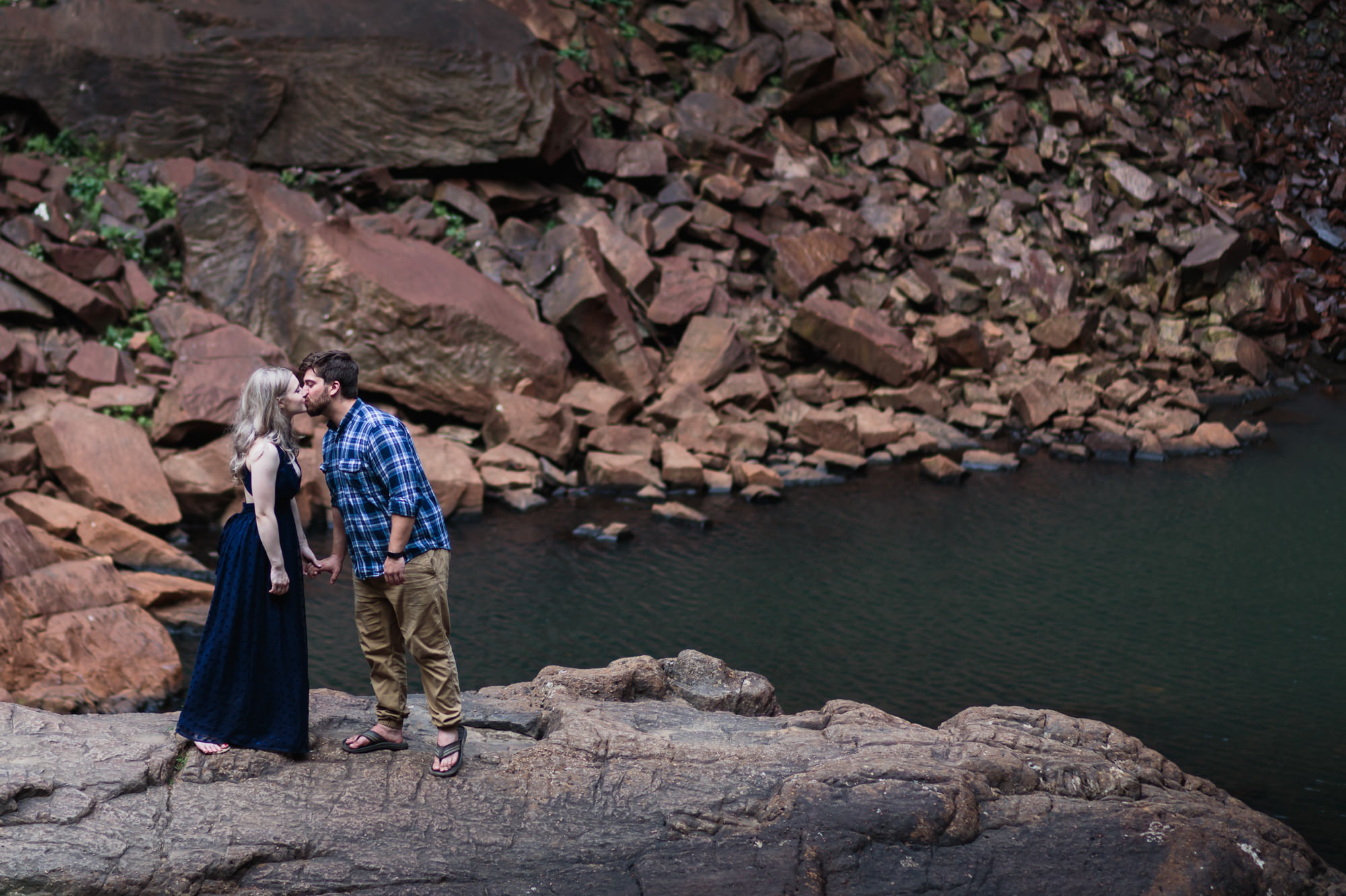 fall creek falls engagement session standing on rock holding hands kissing