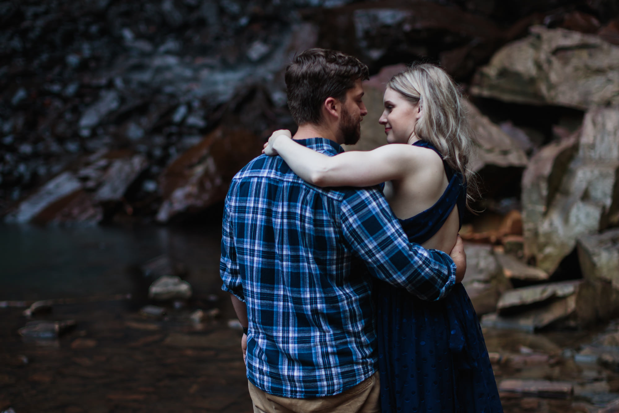 couples photos at fall creek falls with arm around shoulder faces together