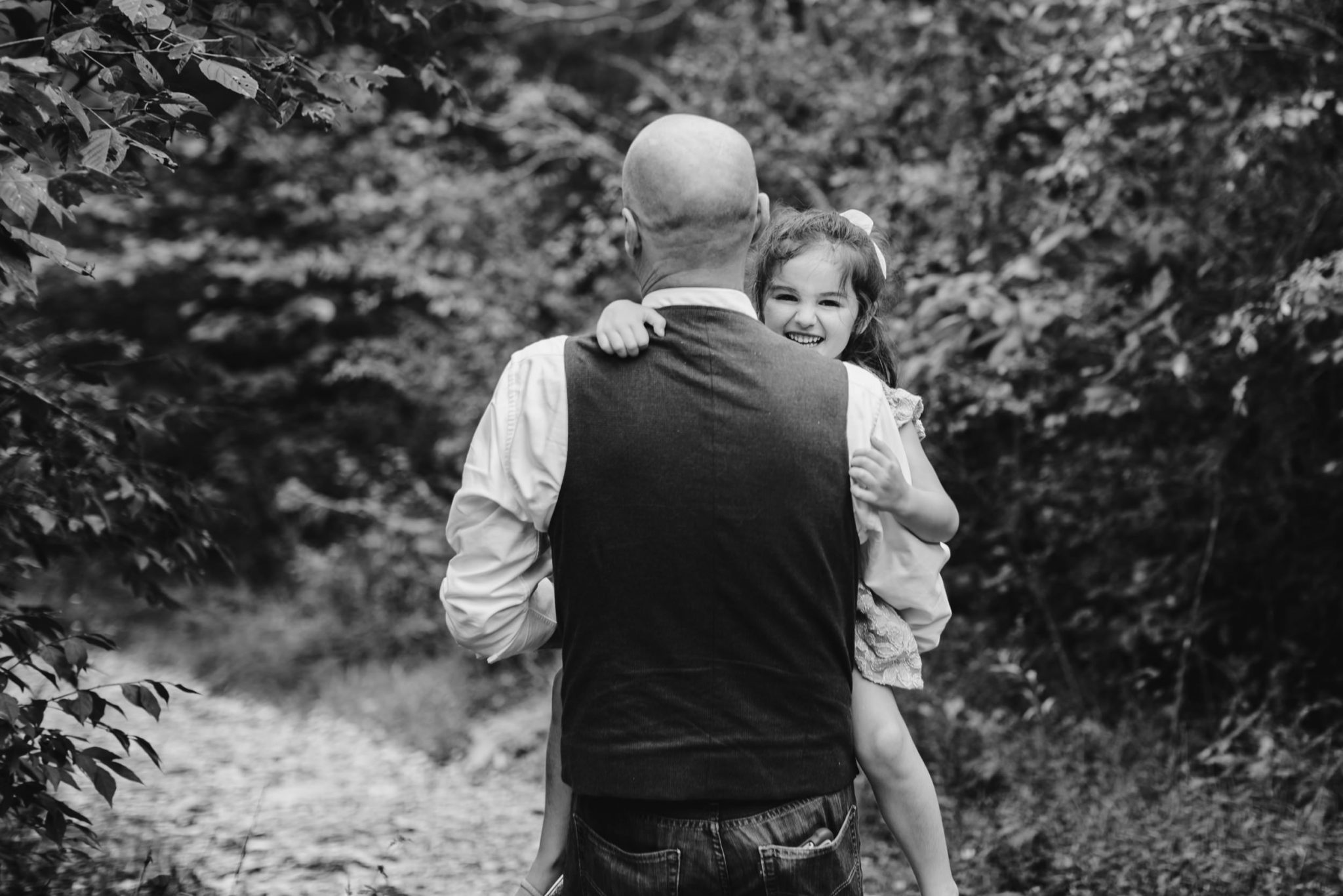 dad carrying daughter on hike
